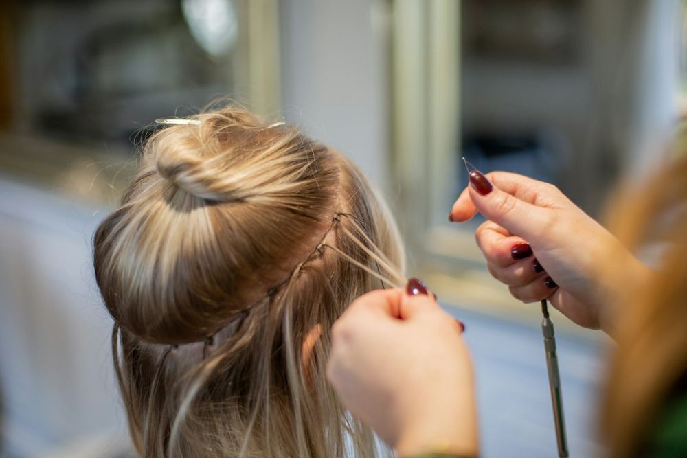 One by one hair extensions being installed strand by strand