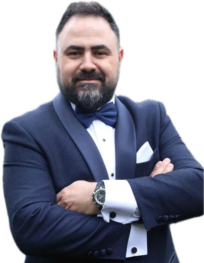 Rami Roumieh, hair designer, in a navy tuxedo with a bow tie